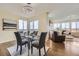 Bright dining area with modern light fixture, large windows, and seating for four, great for gatherings at 12291 Coral Burst Ct, Parker, CO 80134