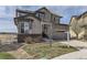 Home exterior shows a tidy lawn, a two-car garage, and neutral colors, creating a welcoming curb appeal at 12291 Coral Burst Ct, Parker, CO 80134