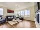 Bright living room with hardwood floors, large windows, and comfortable seating at 12291 Coral Burst Ct, Parker, CO 80134