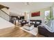 Open-concept living room with hardwood floors and ample natural light, perfect for entertaining and relaxing at 12291 Coral Burst Ct, Parker, CO 80134