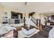 Cozy living room with fireplace, built-in shelving, and hardwood floors at 12291 Coral Burst Ct, Parker, CO 80134