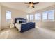 Spacious main bedroom with large windows and a stylish blue upholstered bed at 12291 Coral Burst Ct, Parker, CO 80134