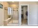 Walk-in shower with tile surround, built-in seat, and glass enclosure, next to closet at 12291 Coral Burst Ct, Parker, CO 80134