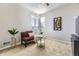 Relaxing sitting area with a red love seat, table, plants and bright natural light at 12291 Coral Burst Ct, Parker, CO 80134