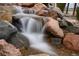 Relaxing rock garden features a gentle waterfall, bringing nature and tranquility to the property at 12291 Coral Burst Ct, Parker, CO 80134