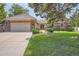 Brick ranch home with attached garage and landscaped lawn at 8272 Bighorn Ct, Lone Tree, CO 80124