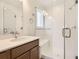 Bathroom featuring vanity with stone countertop and glass-enclosed shower at 4327 E 98Th Pl, Thornton, CO 80229