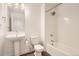 Well lit bathroom features a pedestal sink, toilet, shower, and tub at 4327 E 98Th Pl, Thornton, CO 80229