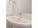 Modern bathroom with a pedestal sink and matching chrome fixtures and hardware at 4327 E 98Th Pl, Thornton, CO 80229