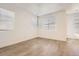 Bright bedroom with sleek laminate floors, white walls and three large windows providing natural light at 4327 E 98Th Pl, Thornton, CO 80229