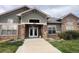 Inviting exterior of a building featuring a stone facade, green accents and well maintained landscaping at 4327 E 98Th Pl, Thornton, CO 80229