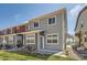 Exterior view of the townhome featuring gray siding, landscaping, and patio at 4327 E 98Th Pl, Thornton, CO 80229