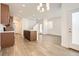 Open kitchen featuring an island, wood cabinets, modern flooring, and stainless steel appliances at 4327 E 98Th Pl, Thornton, CO 80229