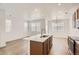 Kitchen flows into dining area with oversized island and modern stainless appliances at 4327 E 98Th Pl, Thornton, CO 80229