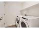 Laundry room featuring a white washer and dryer with a shelf at 4327 E 98Th Pl, Thornton, CO 80229