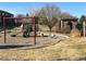 Community playground featuring a swing set, spring rider, and slide at 4327 E 98Th Pl, Thornton, CO 80229