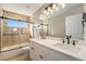 Modern bathroom featuring double vanity, luxurious countertops, and a glass-enclosed shower at 2409 W 38Th Ave, Denver, CO 80211