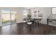 Dining area featuring hardwood floors, modern lighting, and sliding glass door to backyard at 2409 W 38Th Ave, Denver, CO 80211