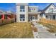 Modern two-story home with stone accents, balcony, xeriscaped front yard, and concrete steps at 2409 W 38Th Ave, Denver, CO 80211