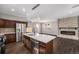 Modern kitchen with island, stainless steel appliances, and open view to fireplace at 2409 W 38Th Ave, Denver, CO 80211