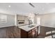 Open concept island kitchen leading into living room with fireplace and hardwood floors at 2409 W 38Th Ave, Denver, CO 80211