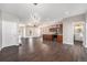 Open-concept living space with kitchen, dining area, hardwood floors, and modern lighting at 2409 W 38Th Ave, Denver, CO 80211