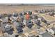 Aerial view of a single Gathering home with a large yard surrounded by other houses in a neighborhood at 4844 Mt Evans St, Brighton, CO 80601
