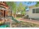 View of home's backyard with wooden playset and mature landscaping at 4844 Mt Evans St, Brighton, CO 80601