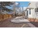 Large concrete patio and backyard perfect for outdoor living with mature trees and play structure at 4844 Mt Evans St, Brighton, CO 80601