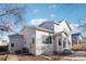 Rear exterior view with neutral siding, multiple windows, and access to the backyard area at 4844 Mt Evans St, Brighton, CO 80601