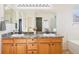 Bathroom with double sink vanity, granite countertops, and ample storage space at 4844 Mt Evans St, Brighton, CO 80601