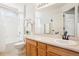 Well-lit bathroom with a shower-tub combo, vanity, and mirror at 4844 Mt Evans St, Brighton, CO 80601