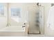 Bathroom featuring a soaking tub and separate shower with bright, natural light at 4844 Mt Evans St, Brighton, CO 80601