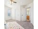 Carpeted bedroom with closet and open door to the bathroom at 4844 Mt Evans St, Brighton, CO 80601