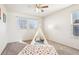 Light-filled bedroom with carpet, a large window, and a fun teepee with a colorful rug at 4844 Mt Evans St, Brighton, CO 80601