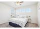 Bright bedroom with neutral tones, carpet floors, and ample natural light from three windows at 4844 Mt Evans St, Brighton, CO 80601
