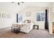 Bright bedroom with neutral tones, carpet floors, and ample natural light from large windows at 4844 Mt Evans St, Brighton, CO 80601