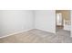 Empty bedroom with neutral paint, carpet, and a view of the stairway at 4844 Mt Evans St, Brighton, CO 80601