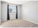 Clean, carpeted bedroom with a window and neutral wall color at 4844 Mt Evans St, Brighton, CO 80601