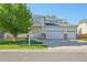 Inviting two-story home with a manicured lawn and attached three-car garage for ample parking at 4844 Mt Evans St, Brighton, CO 80601