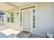 Welcoming front porch with charming 'Oh, Hello' doormat and bright windows at 4844 Mt Evans St, Brighton, CO 80601