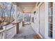 Inviting covered front porch with white railing and brick accents leading to the entrance at 4844 Mt Evans St, Brighton, CO 80601