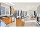 Open kitchen featuring an island, breakfast bar, wood cabinets, and stainless steel appliances at 4844 Mt Evans St, Brighton, CO 80601