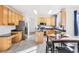 Spacious kitchen featuring stainless steel appliances, black marbled counters, wood cabinets, and an island at 4844 Mt Evans St, Brighton, CO 80601