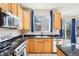 Well-lit kitchen showcasing black marbled countertops and stainless steel appliances at 4844 Mt Evans St, Brighton, CO 80601