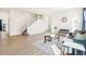 Spacious living room featuring wood floors, a staircase, large windows, and modern decor at 4844 Mt Evans St, Brighton, CO 80601