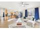 Open-concept living room and kitchen with hardwood floors, modern lighting, and natural light at 4844 Mt Evans St, Brighton, CO 80601