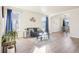 Open-concept living room with hardwood floors, large windows, stylish decor, and comfortable seating at 4844 Mt Evans St, Brighton, CO 80601