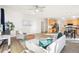 Open concept living room with hardwood flooring and a ceiling fan at 4844 Mt Evans St, Brighton, CO 80601