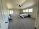 Spacious main bedroom boasts soft carpeting, large windows and a ceiling fan at 4844 Mt Evans St, Brighton, CO 80601